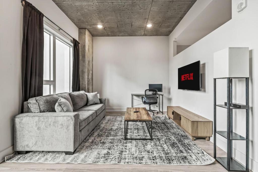 a living room with a couch and a table at Chic Channelside Getaway in DT | Close to DT! in Tampa
