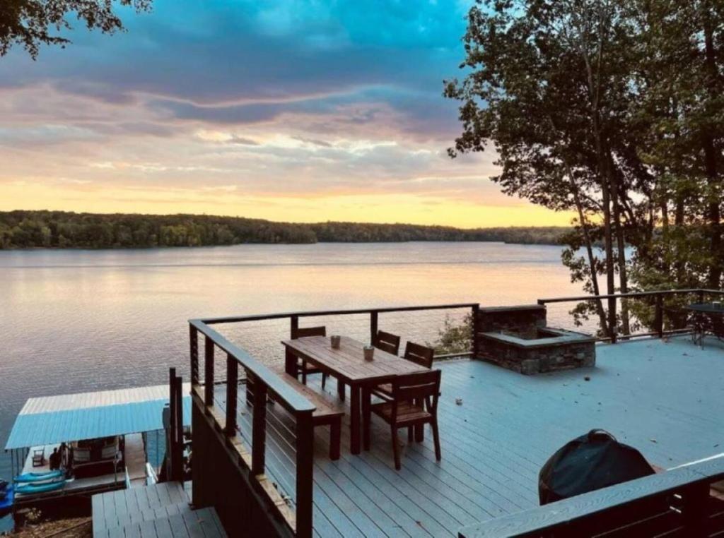 a dock with a table and chairs on the water at Billion Dollar Views in Winchester