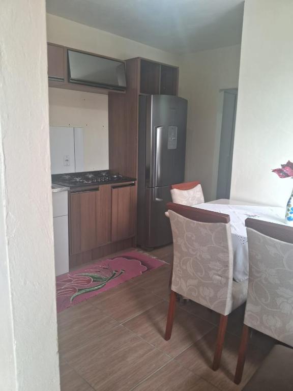a kitchen with a bed and a table and chairs at Casa Torres in Torres