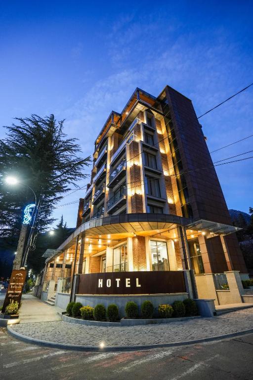 a hotel building with a sign in front of it at Steel Tower Borjomi in Borjomi