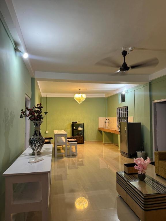 a living room with a vase of flowers on a table at Humble abode Homestay 1BHK with scenic view in Itānagar