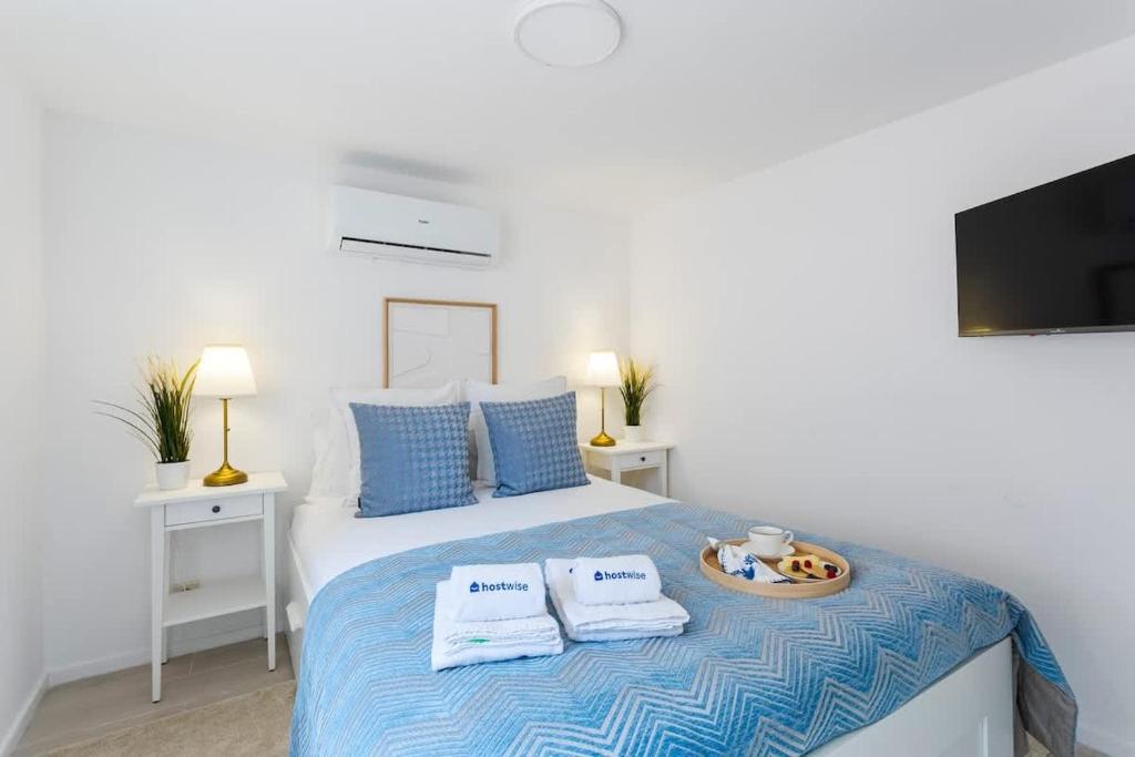 a bedroom with a bed with two towels on it at Authentic Retreat by HostWise in Porto