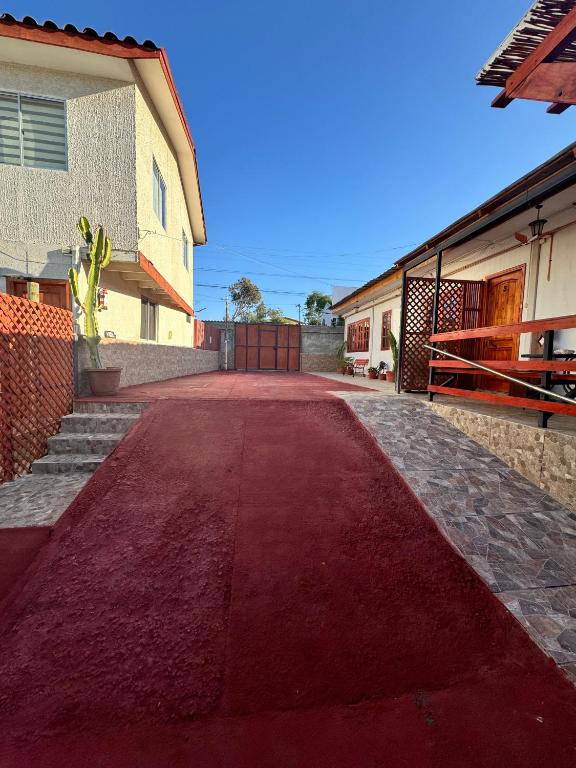 a red road in front of a house at Apart hotel doña ely in Caldera