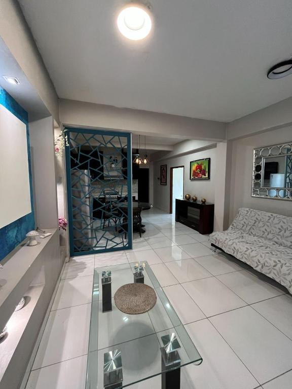 a living room with a couch and a glass table at Departamento en Cuernavaca in Cuernavaca