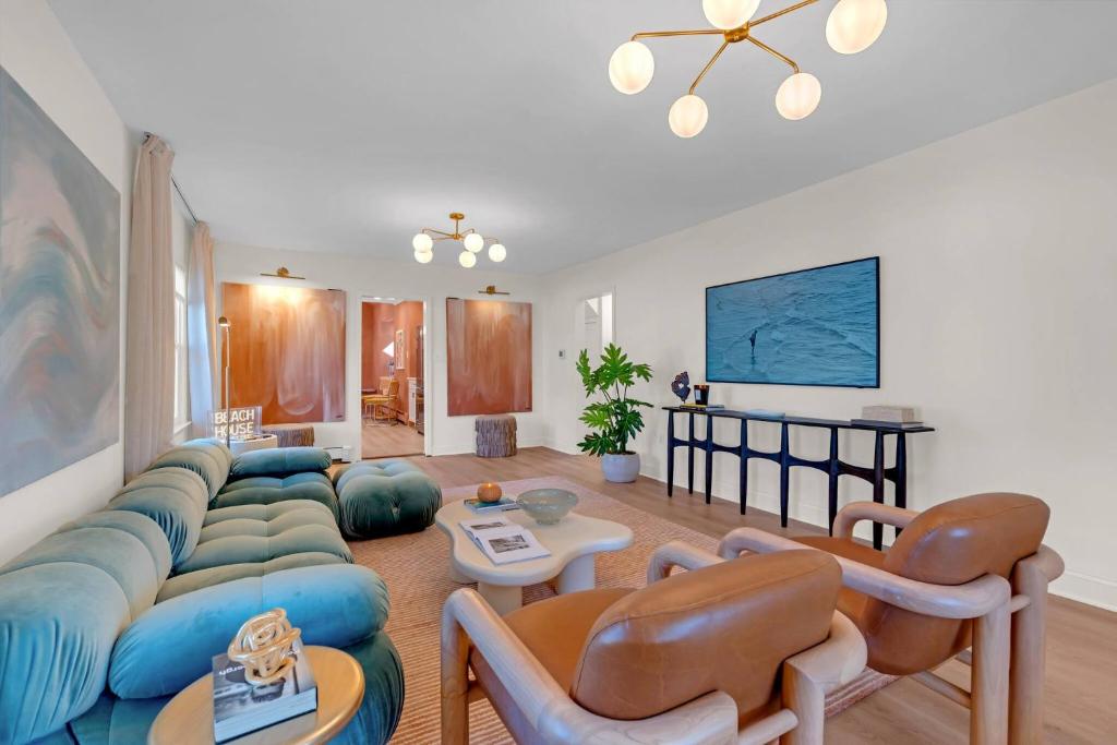 a living room with a blue couch and chairs at 1726 Belmont Ave in Lake Como