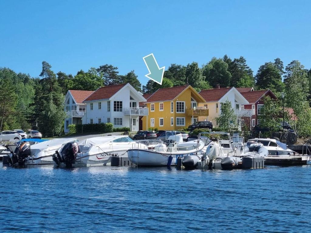 a group of boats docked at a marina on the water at Modern Seaside Cabin Tvedestrand Hantho Brygge in Tvedestrand