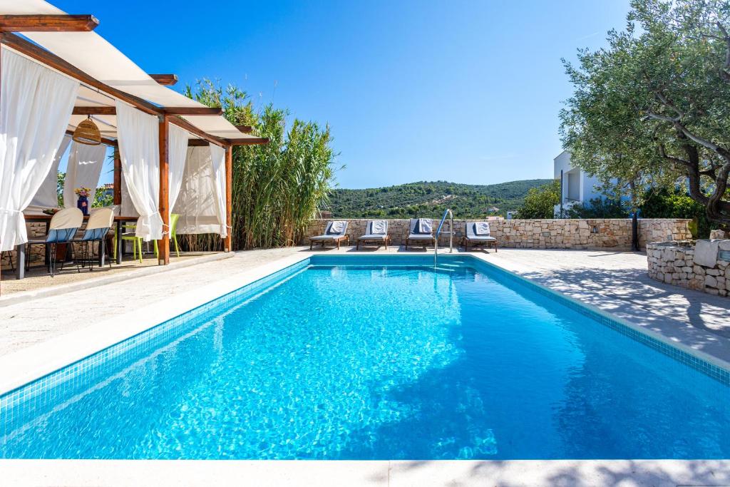 a swimming pool with blue water in a house at Villa Dome in Slatine