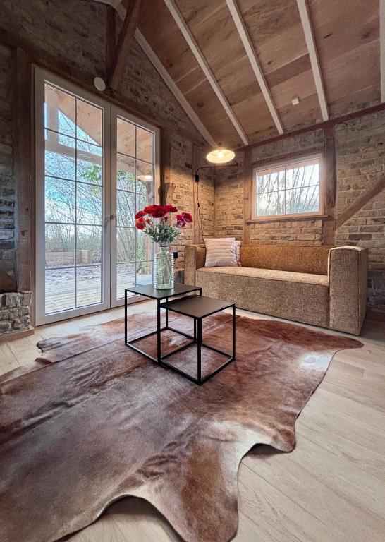 a living room with a large table and a couch at Idyllic cottage with wellness facilities in Alveringem