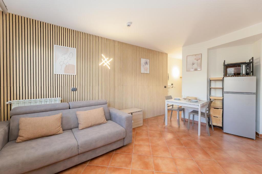 a living room with a couch and a table at Bardonecchia Campo Smith 3 in Bardonecchia
