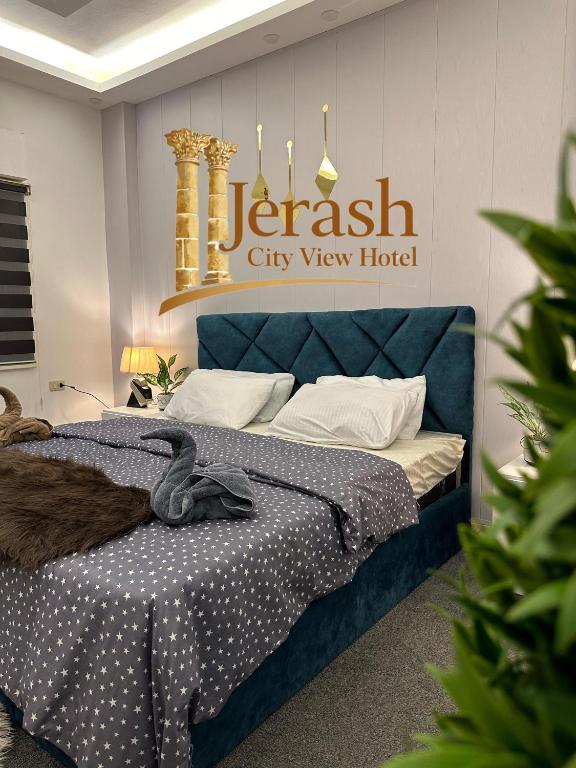 a bedroom with a blue bed and a city view hotel at Jerash City View in Jerash