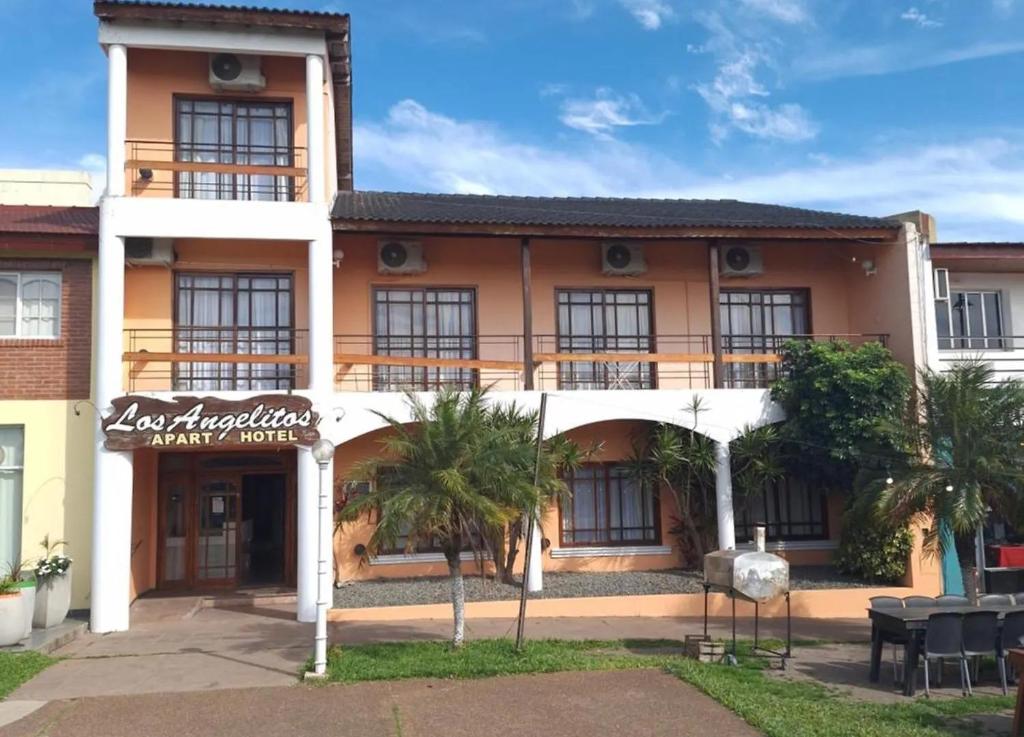 een uitzicht op een gebouw met palmbomen bij Apart Hotel Los Angelitos in Federación