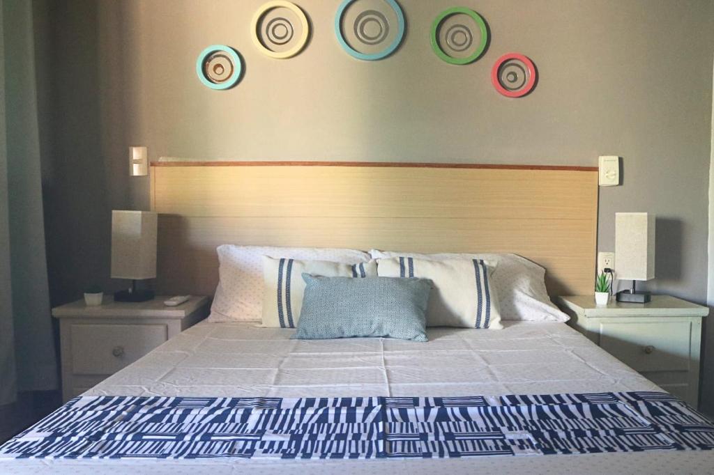 a bedroom with a bed with plates on the wall at Posada Casa Tortuga, Zipolite in Zipolite