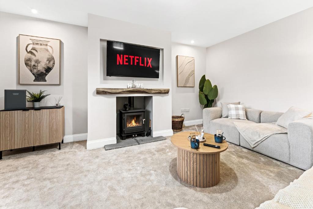 a living room with a couch and a fireplace at Spacious 3BR 3-Bath Modern Home Warrington in Warrington