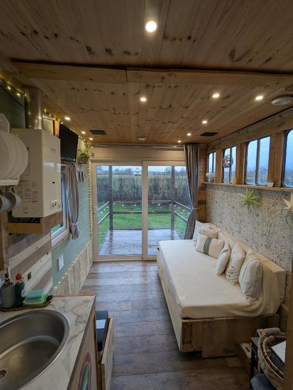 Un dormitorio con una cama y un lavabo en una habitación. en The Horsebox at Wits End, en Hartford
