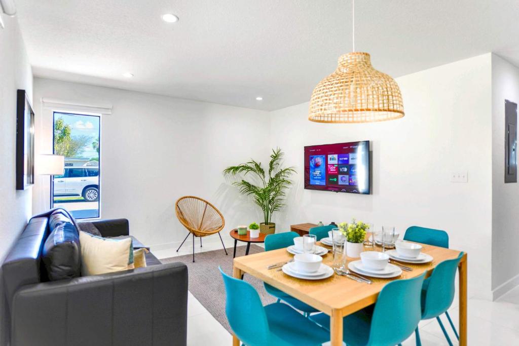 a dining room and living room with a table and chairs at Prime Location Duplex with Free Parking in Miami