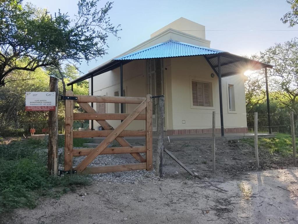 ein kleines Haus mit einem Tor und einem Zaun in der Unterkunft Tacuarita in Los Hornillos