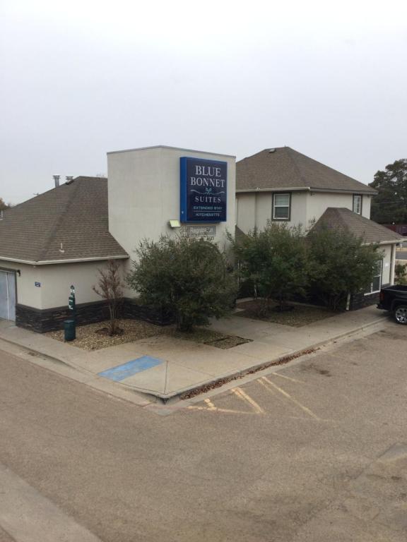 a blue sign on the side of a building at Blue Bonnet Suites -Lubbock, TX - Medical Center in Lubbock