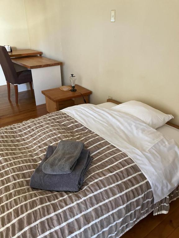 Postel nebo postele na pokoji v ubytování Green House Tsukuba Studio