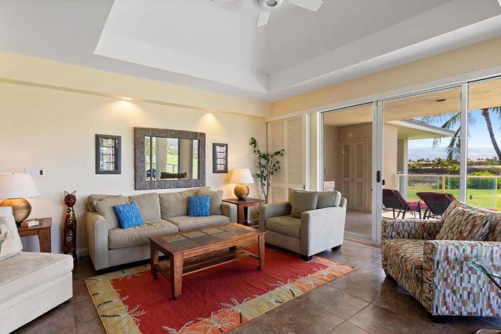 a living room with a couch and a table at Peaceful condo with lanai & beach essentials in Waikoloa