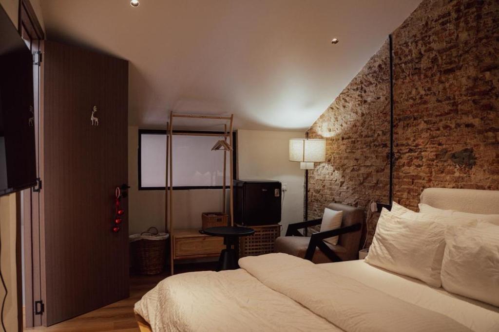 a hotel room with a bed and a tv at The Heritage 1937 in Kuching