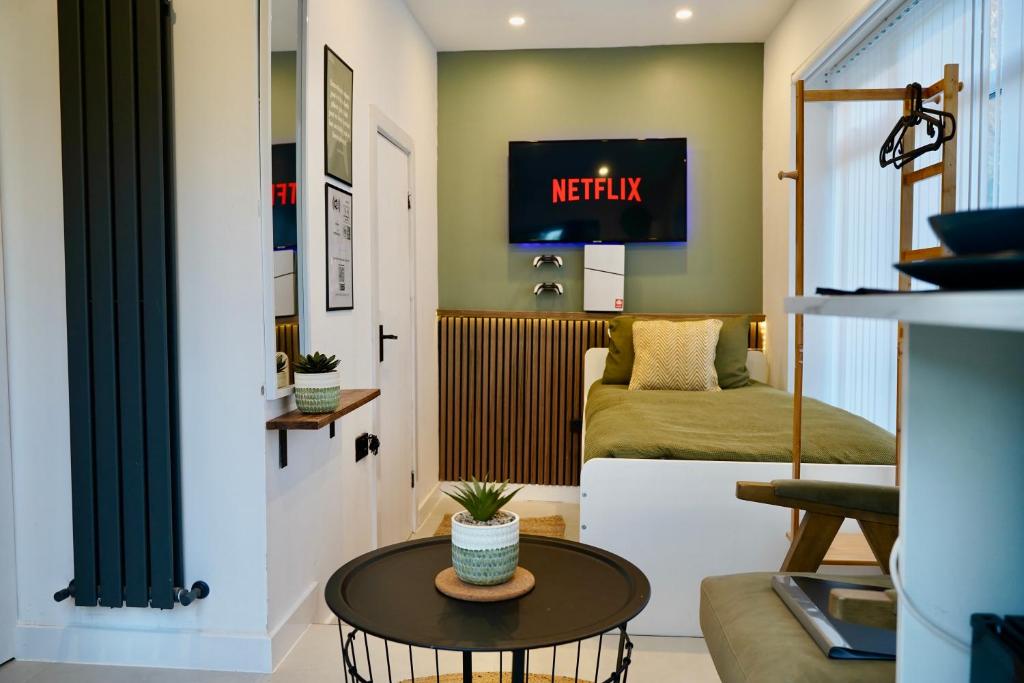 a living room with a couch and a table at The Cozy Cave in Castleton