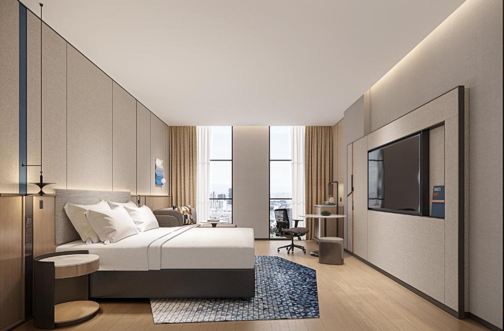 a hotel room with a bed and a tv at Holiday Inn Express Kunming Changshui Airport by IHG in Kunming