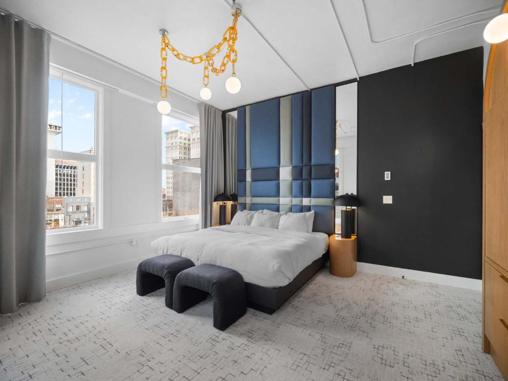 a bedroom with a king sized bed and a large window at Symons Block Suite 7 in Spokane