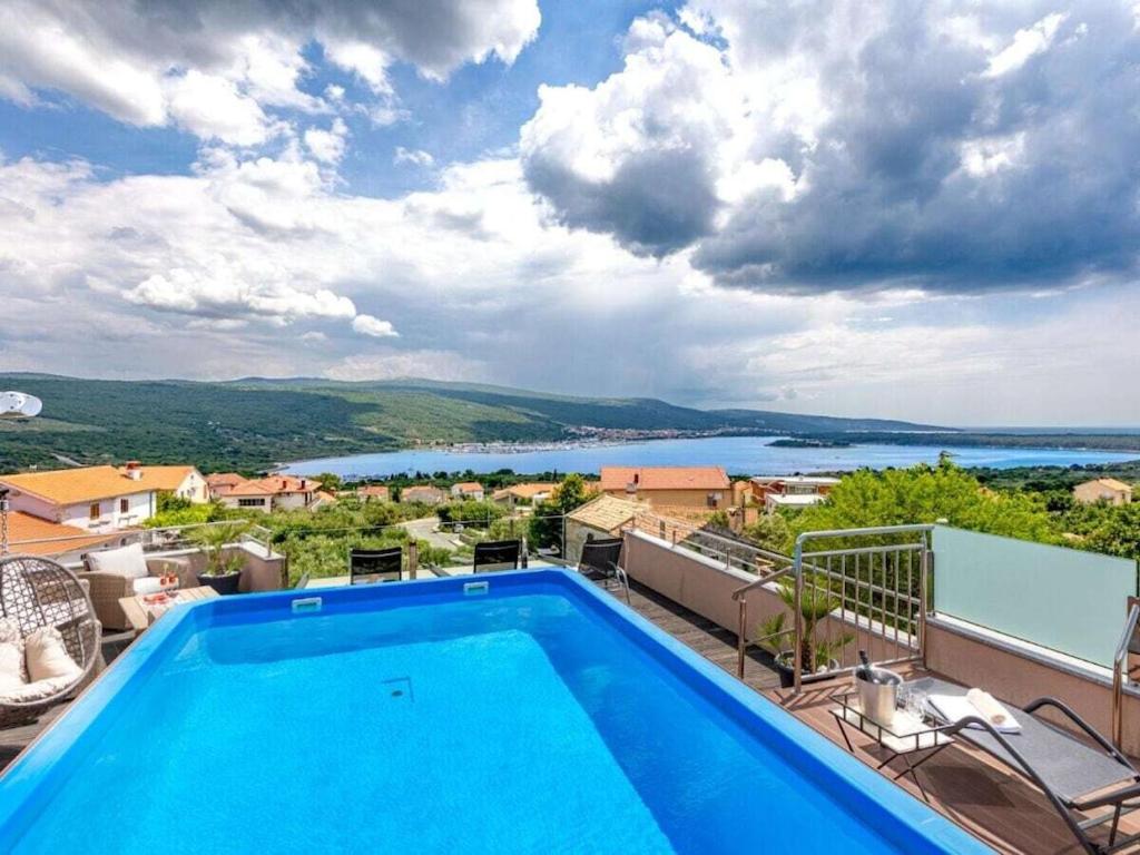 a pool on the balcony of a house with a view at Villa in Korni with swimming pool in Kornić