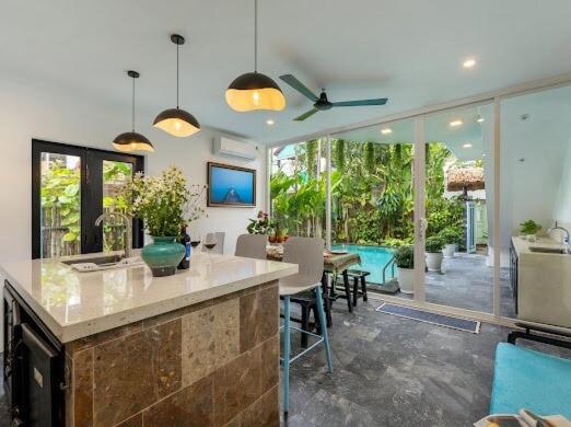 a kitchen and living room with a table and chairs at Emerald Coast House in An Bàn (2)