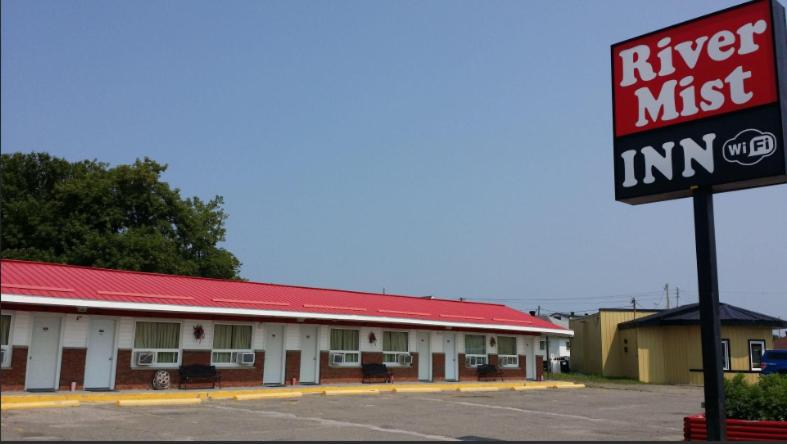 a kings nest inn sign in front of a motel at River Mist INN in Sturgeon Falls