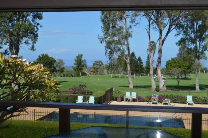 a view of a golf course from a window at Peaceful golf retreat with shared pools in Waikoloa Village