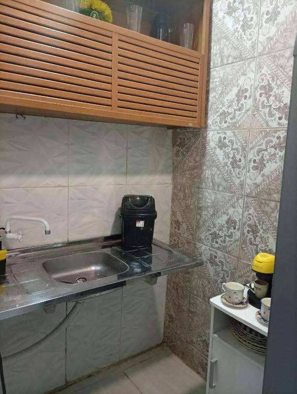 a kitchen with a sink and a counter top at Flat aconchegante na maraponga in Fortaleza