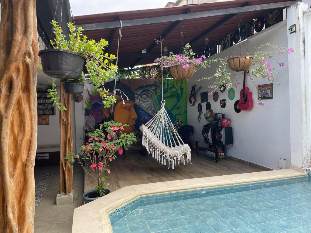a house with a swimming pool and some plants at Casa Hostal los Profes in Mocoa