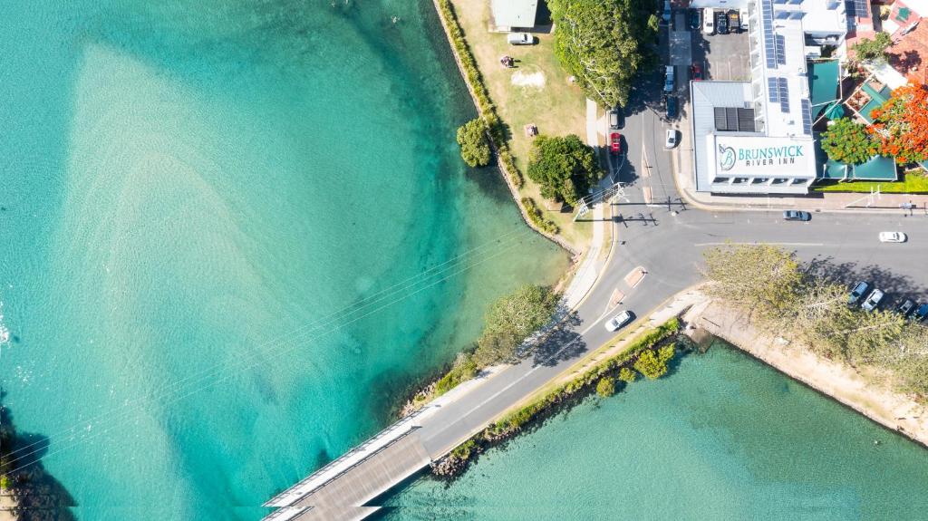 an aerial view of a road next to a body of water at Brunswick River Inn in Brunswick Heads