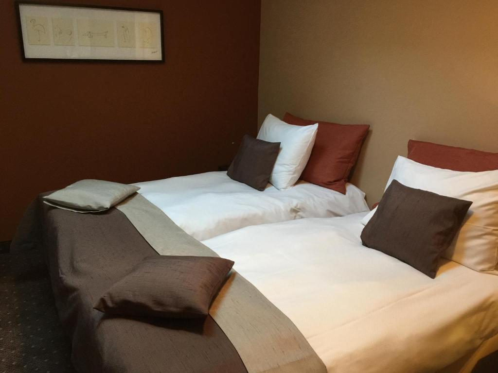 Postel nebo postele na pokoji v ubytování Hotel Malon