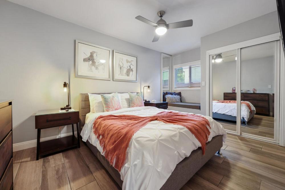 een slaapkamer met een groot bed en een spiegel bij “Backyard Is OMG” Spa Pool BBQ Game Room Views in San Diego