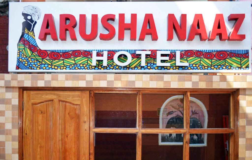 a sign for an arkishica naza hotel above a door at Arusha Naaz Hotel in Arusha