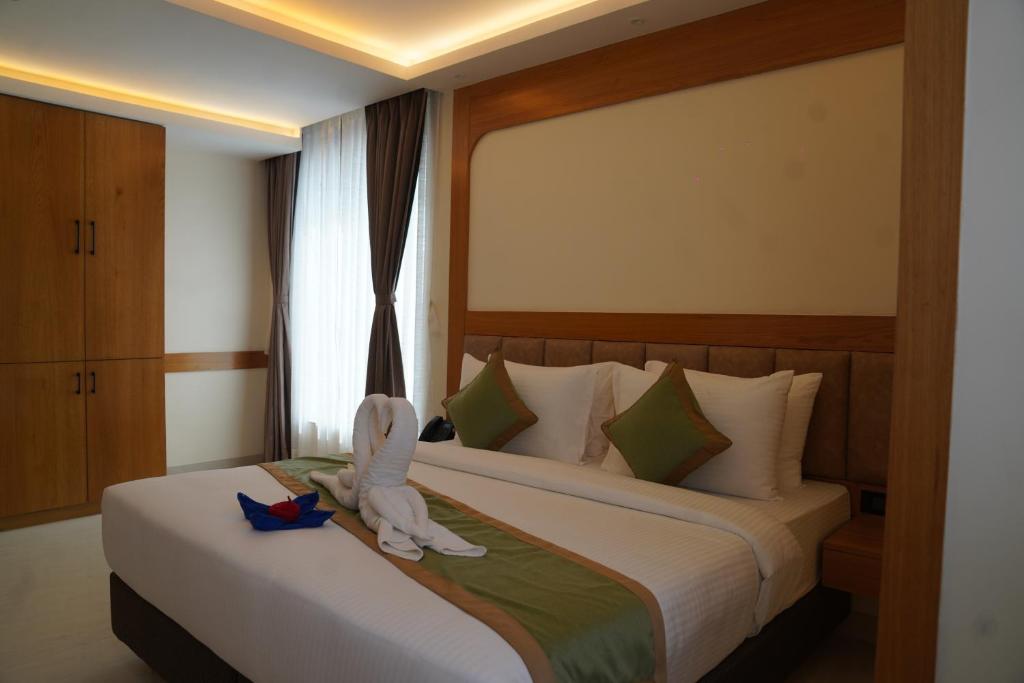 a hotel room with two beds with towels on them at hotel Green view in Baharampur