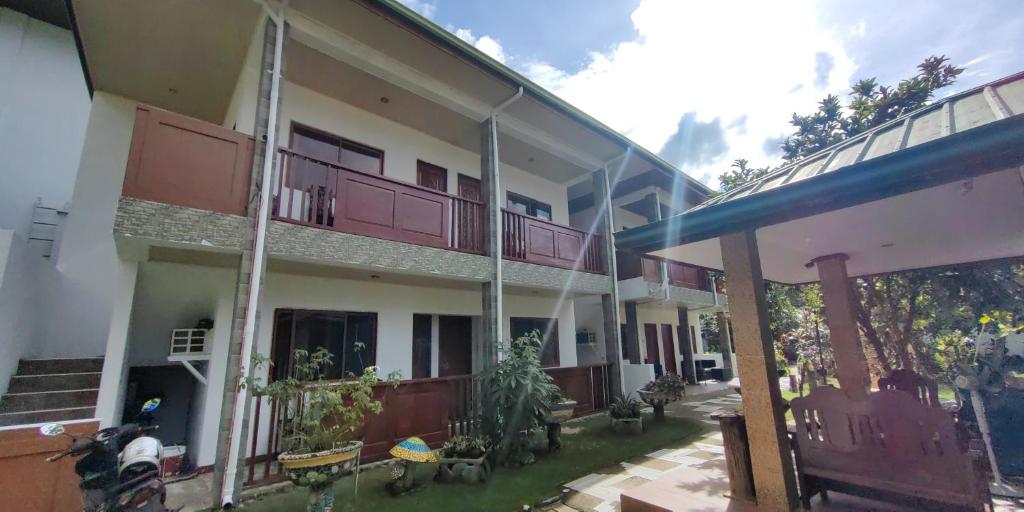 a large apartment building with a patio and balcony at Morning Walsh Resort El Nido in El Nido