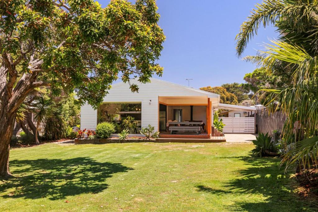 a home with a yard with a fence at Barramundi Beach House in Smiths Beach