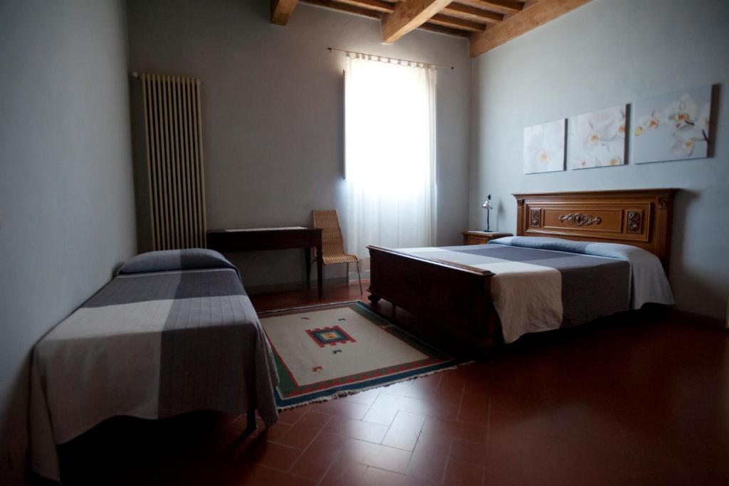 Postel nebo postele na pokoji v ubytování B&B Glicine e Luna