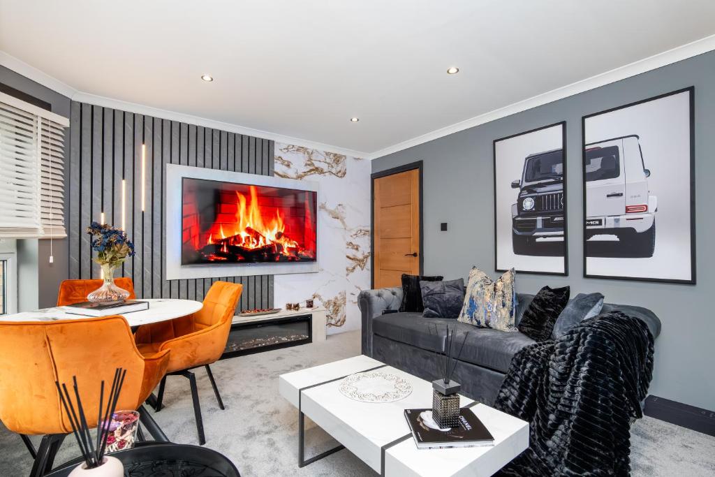 a living room with a couch and a fireplace at The Apartment in Paisley