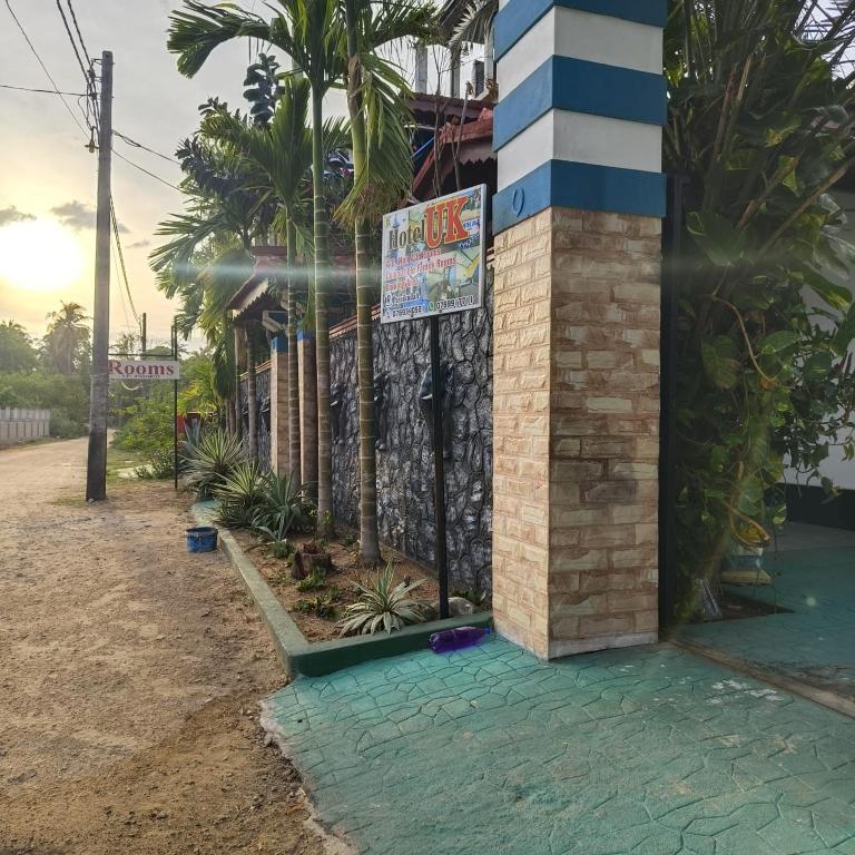 a sign that is on the side of a building at Hotel UK Pasikuda in Kalkudah