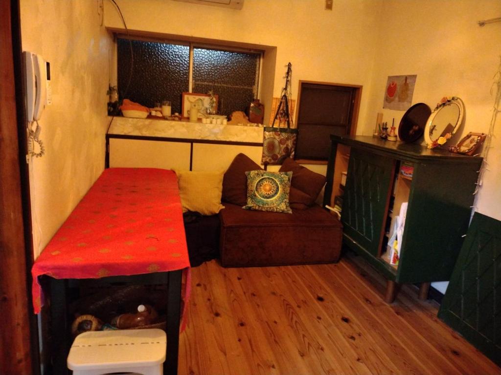 a small living room with a couch and a table at BAz11 in Misaki