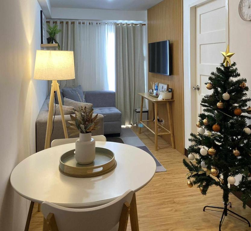 a living room with a christmas tree and a table at EasyStay Condo Davao in Davao City