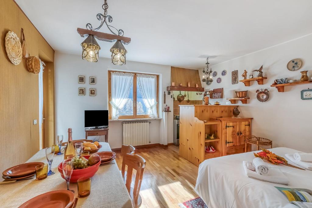 a living room with a table and a dining room at Appartamento Big Lem - Happy Rentals in Sauze d'Oulx
