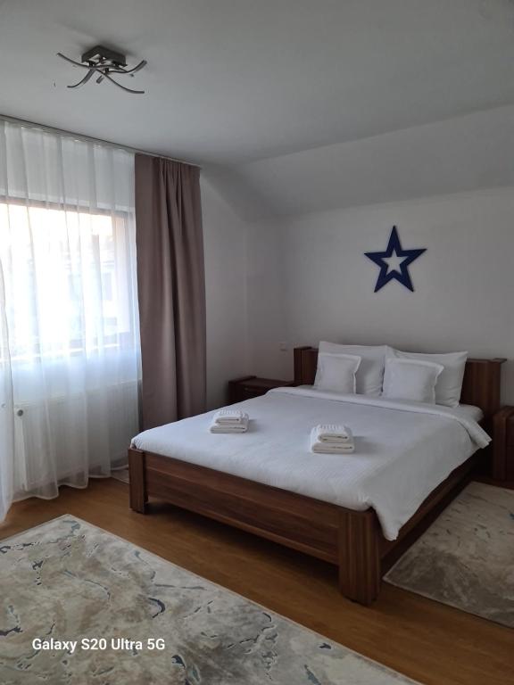 a bedroom with a large bed with a star on the wall at Casa Coresi in Braşov