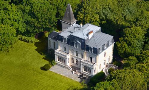 an aerial view of a large white house with a tower at Château de la Marine in Wimille