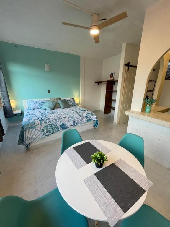 a bedroom with a bed and a table and chairs at Casa Dreamy in Zihuatanejo