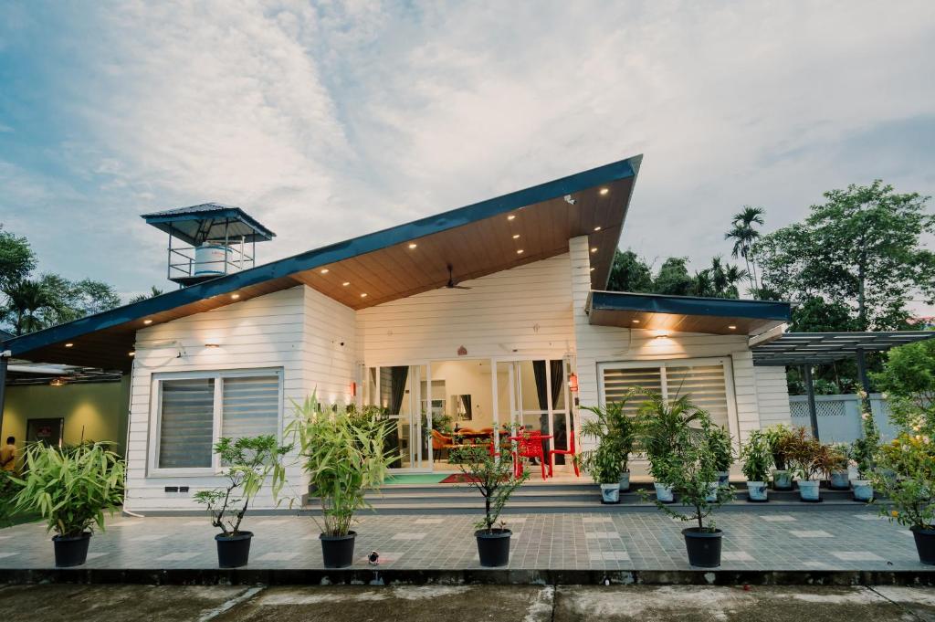 a house with plants in front of it at Vanilla Country in Dibrugarh
